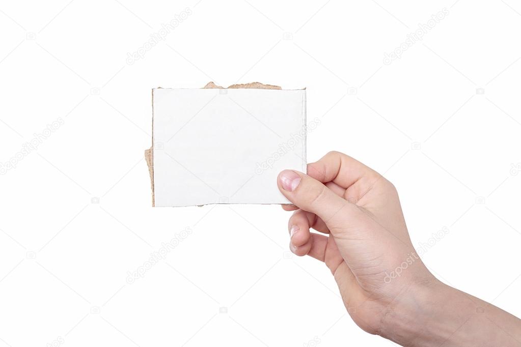 one hand holding a white piece of cardboard