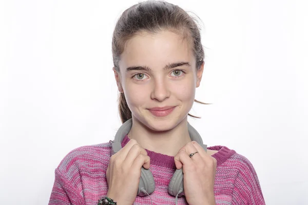 Smiling female teenager with headphones, isolated on white — Stock Photo, Image