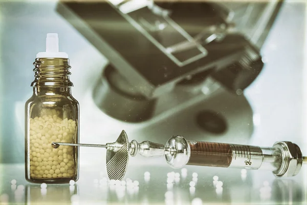 Vintage still life with homeopathy globules, syringe with blood — Stock Photo, Image