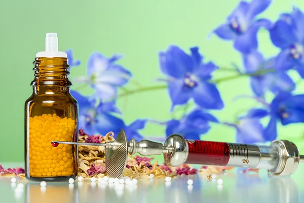 Still life with homeopathy globule, syringe with blood, some spi — Stock Photo, Image