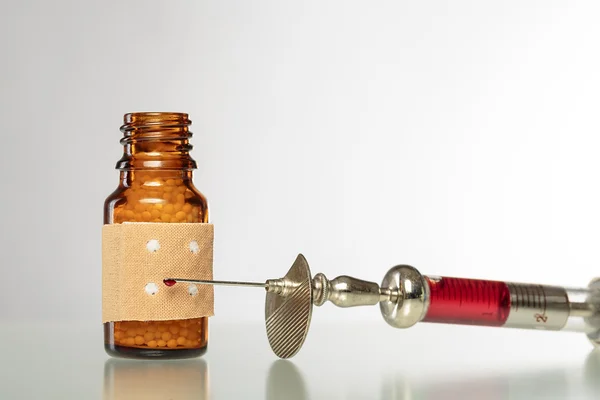 Still life with homeopathy globules. syringe with blood and  pla — Stock Photo, Image