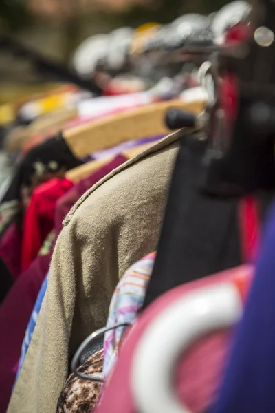 Clothes on a rack on a flea market — Stock Photo, Image