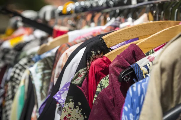 Clothes on a rack on a flea market — Stock Photo, Image