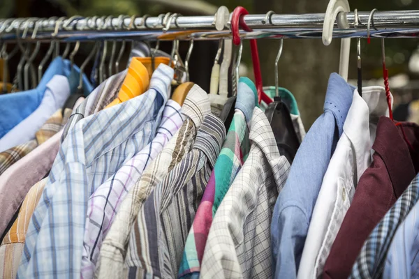 Clothes on a rack on a flea market — Stock Photo, Image