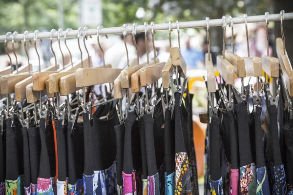 Clothes on a rack on a flea market — Stock Photo, Image