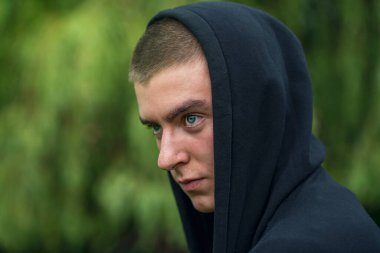 portrait of young serious man wearing hoodie