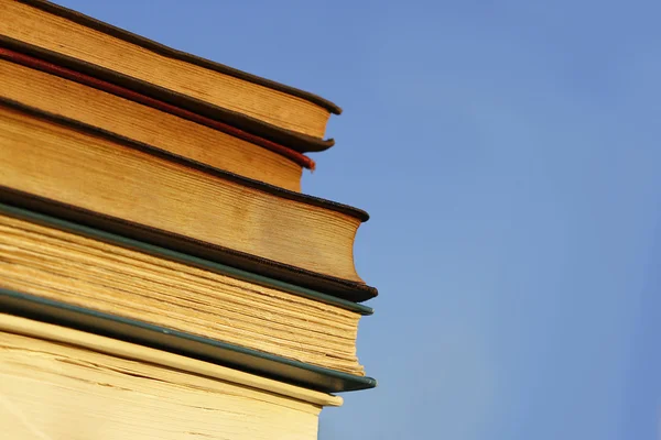 Böcker framför blå himmel — Stockfoto