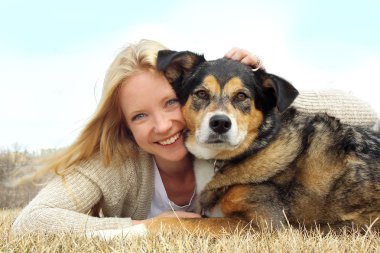 Smiling Woman Hugging German Shepherd Dog clipart