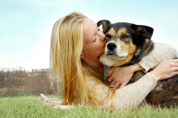 Lächelnde Frau umarmt Schäferhund — Stockfoto