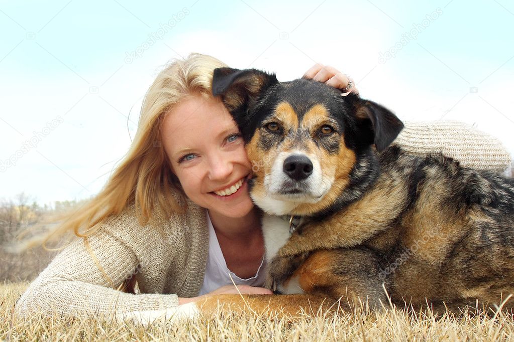 Smiling Woman Hugging German Shepherd Dog