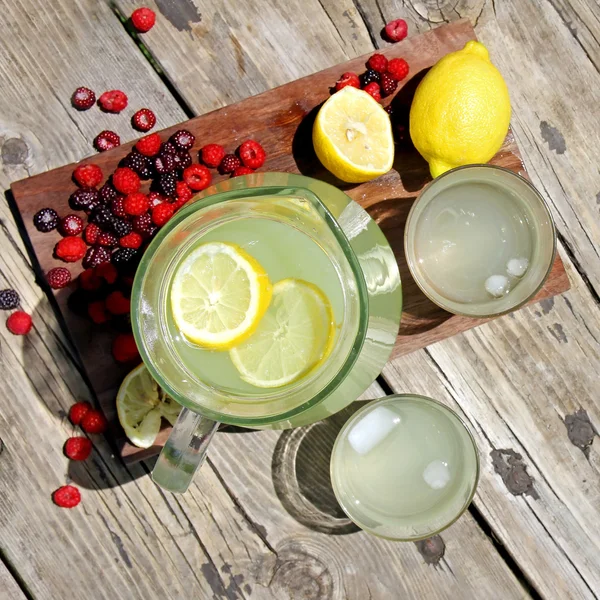 Fresh Lemonade and Fruit Framing Rustic Wood Background