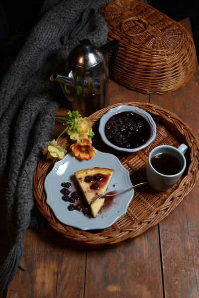 Evening tea with jam and a piece of cake. The cozy atmosphere of the cafe helps to relax and relax in silence.