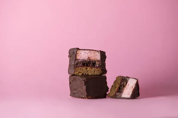 A piece of chocolate lingonberry cake with mousse on a bright background. isolated object. space for copying. traditional Scandinavian baking recipes. advertising of a coffee shop or restaurant.menu