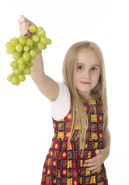 Girl in a beautiful dress with grapes — Stock Photo, Image