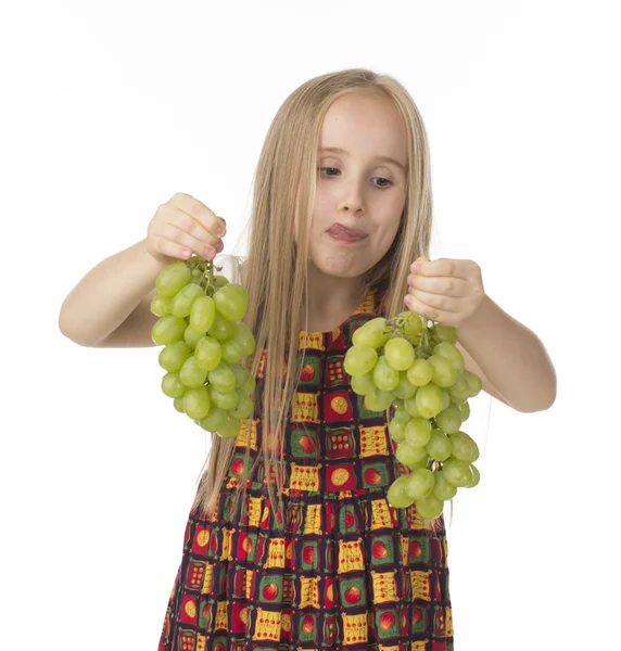 Girl in a beautiful dress with grapes — Stock Photo, Image