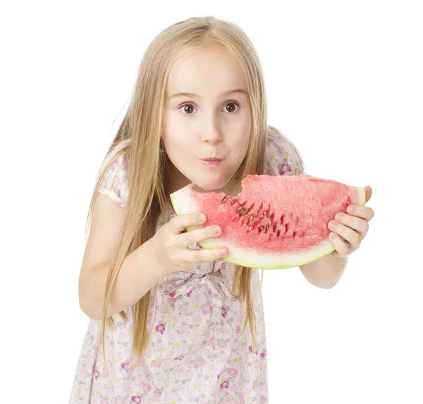 Girl in a dress eating watermelon — Stock Photo, Image