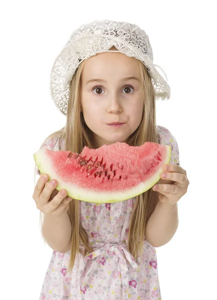 Girl in a dress eating watermelon — Stock Photo, Image