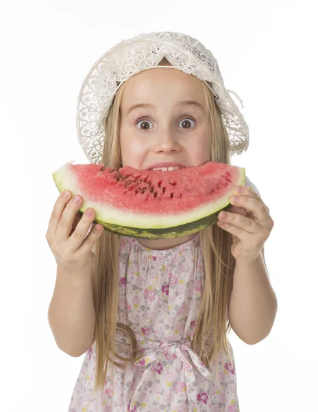 Girl in a dress eating watermelon — Stock Photo, Image