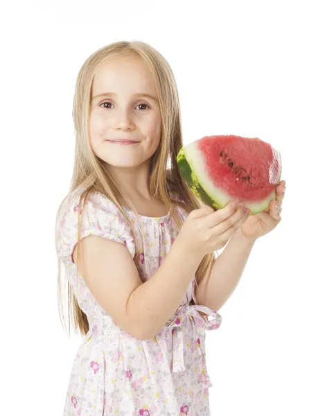 Girl in a dress eating watermelon — Stock Photo, Image