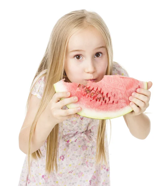 Girl in a dress eating watermelon — Stock Photo, Image