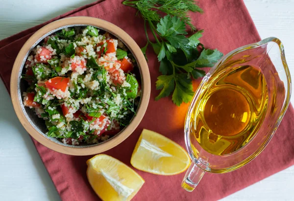 Traditional Arabic Salad Tabbouleh with couscous, parsley, tomato and olive oil — Stockfoto
