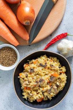 Hafif arka planda mantarlı vejetaryen pilav. Dikey fotoğraf. Üst görünüm.