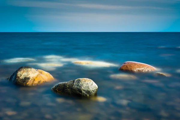 Three rocks in the calm water