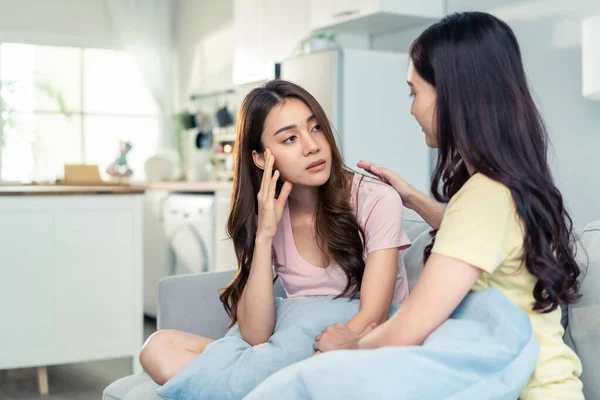 Asian beautiful woman comforts upset girl friend crying for problem. Attractive carring female support, consoling and understand empathy to stressed young sister in tears at home. Family relationship.