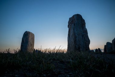 Evening twilight picture of Ales Stenar megalithic stone ship monument in mystic atmosphere taken from a low perspective.