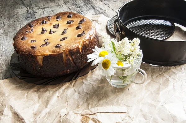 Cheesecake met een boeket van madeliefjes. horizontale schot. — Stockfoto