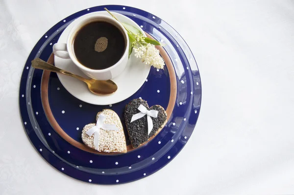 Zwei Hochzeitsplätzchen mit einer Tasse Kaffee auf dem Teller — Stockfoto