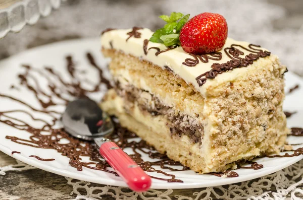 Slice of homemade nutty cake with strawberries served spoon — Stock Photo, Image