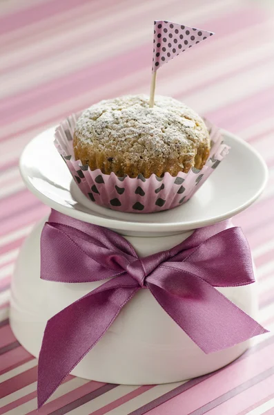 Pumpkin cupcake on white cup decoreted with satin silk bow — Stock Photo, Image