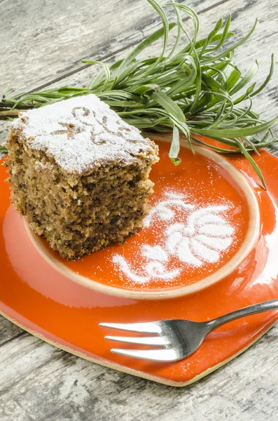 Pumpkin cake on orange plate with lavender lives — Stock Photo, Image