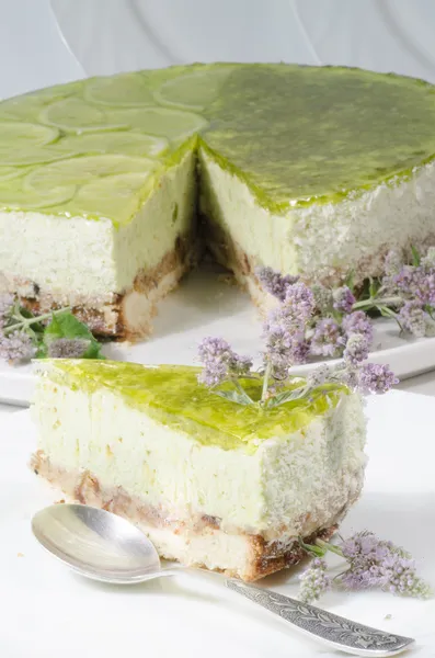 Lime cheesecake decorated with mint flowers — Stock Photo, Image