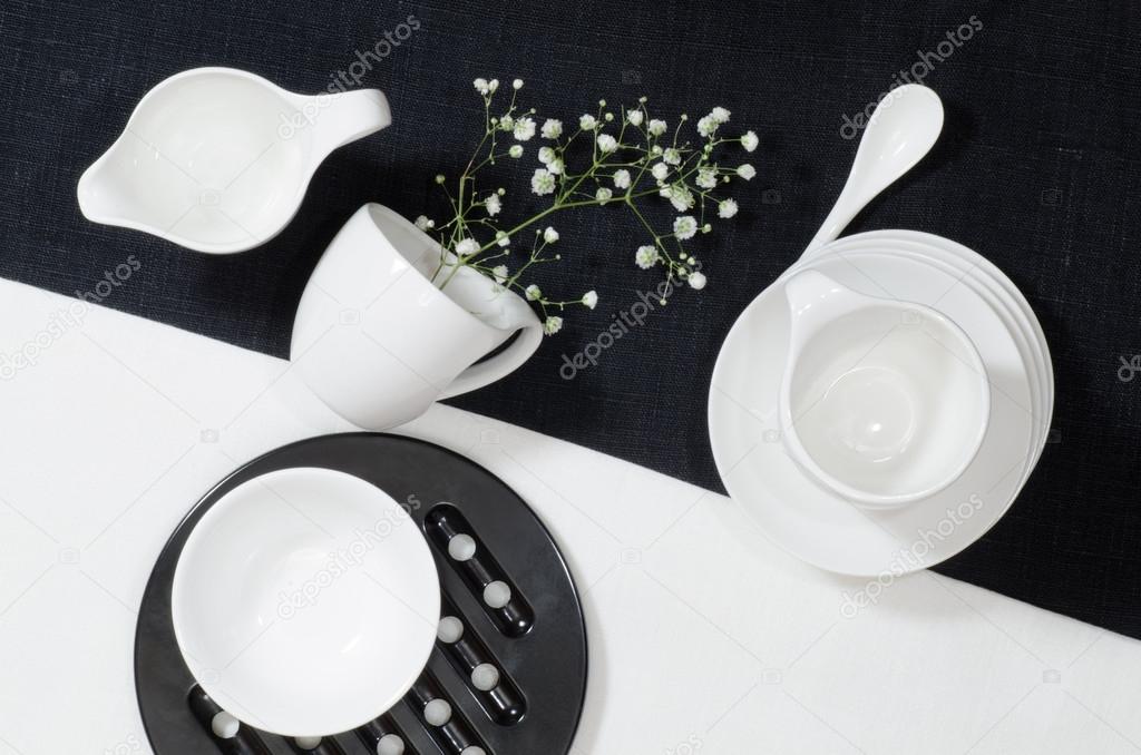 White porcelain on black and white linen tablecloths.