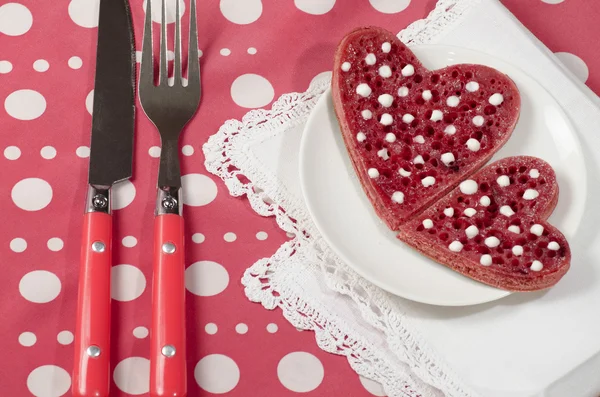 Valentine's Day red pancakes in heart shape with sour cream — Stock Photo, Image