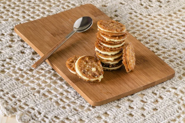 Caramel Florentines cookies on a wooden cutting board — Stock Photo, Image