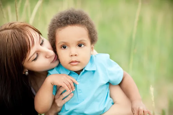 Multi-Ethnic family relaxing together outdoors — Stock Photo, Image