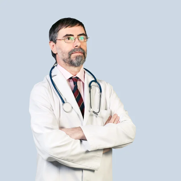 Portrait of serious middle-aged doctor with stethoscope, looking — Stock Photo, Image