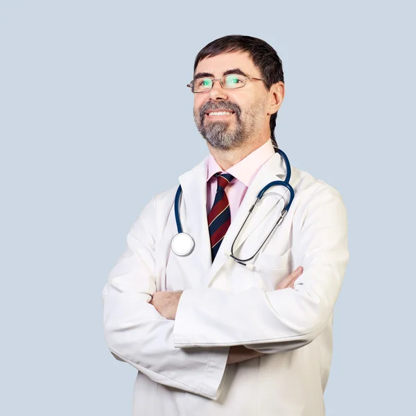 Portrait of happy middle-aged doctor with stethoscope, looking a — Stock Photo, Image