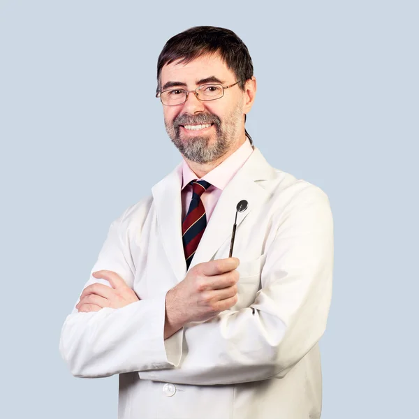 Portrait of happy middle-aged dentist on a pale background, wear — Stock Photo, Image