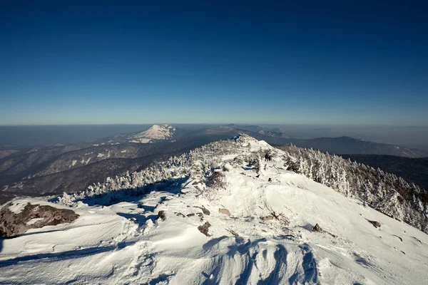 Winter landscape of mountains with snow under blue cloudy sky. R — Stock Photo, Image