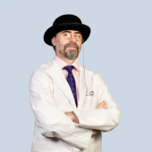 Portrait of middle-aged retro doctor in a hat .on a pale backg — Stock Photo, Image