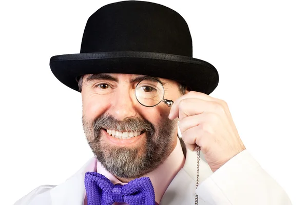 Portrait of happy middle-aged man in a hat with a monocle in his — Stock Photo, Image
