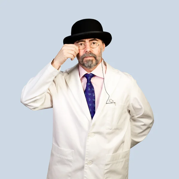 Portrait of middle-aged retro doctor in a hat .on a pale backg — Stock Photo, Image