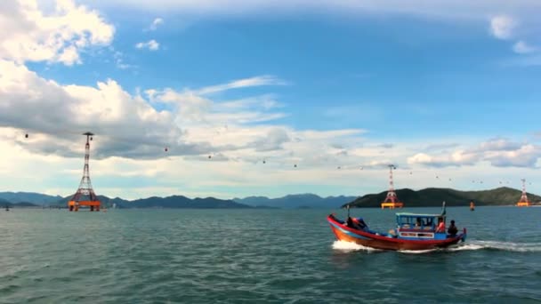 Motor boat in Nha Trang Bay on a background of cable car Vinpearl, Vietnam. — Stock Video