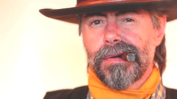 Closeup portrait of cowboy smoking cigar. on white background — Stock Video