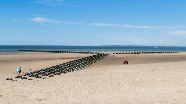 RNLI quad bike monitoring the incoming tide on Wallasey beach near Liverpool (England) in July 2020.