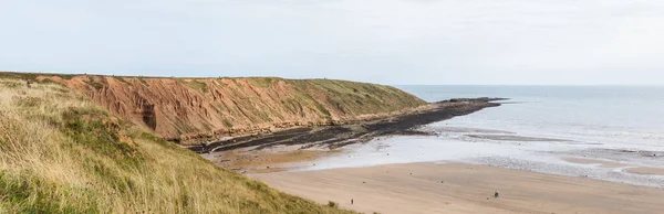 Multiple image panorama of Filey Brigg as it juts out into the North Sea.